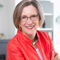 women in red jacket wearing glasses