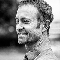 black and white profile image of man in collared shirt